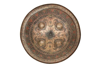 Lot 142 - A KASHMIRI ENGRAVED AND POLYCHROME ENAMELLED BRASS SHIELD (DHAL)