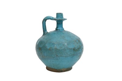 Lot 362 - A MONOCHROME TURQUOISE-GLAZED KASHAN POTTERY EWER