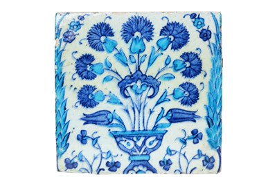 Lot 147 - AN IZNIK POTTERY TILE WITH A FLOWER VASE