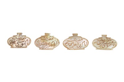 Lot 146 - λ FOUR CARVED MOTHER-OF-PEARL TALISMANIC PENDANTS ENGRAVED WITH SHI'A IMAM NAMES