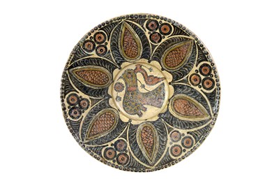Lot 252 - A LARGE SAMANID SARI-WARE SLIP-PAINTED POTTERY BOWL WITH BIRD MOTIF