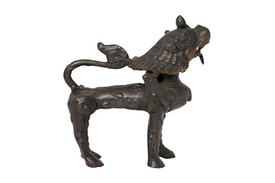Lot 104 - A TIBETAN BRONZE MODEL OF A LION
