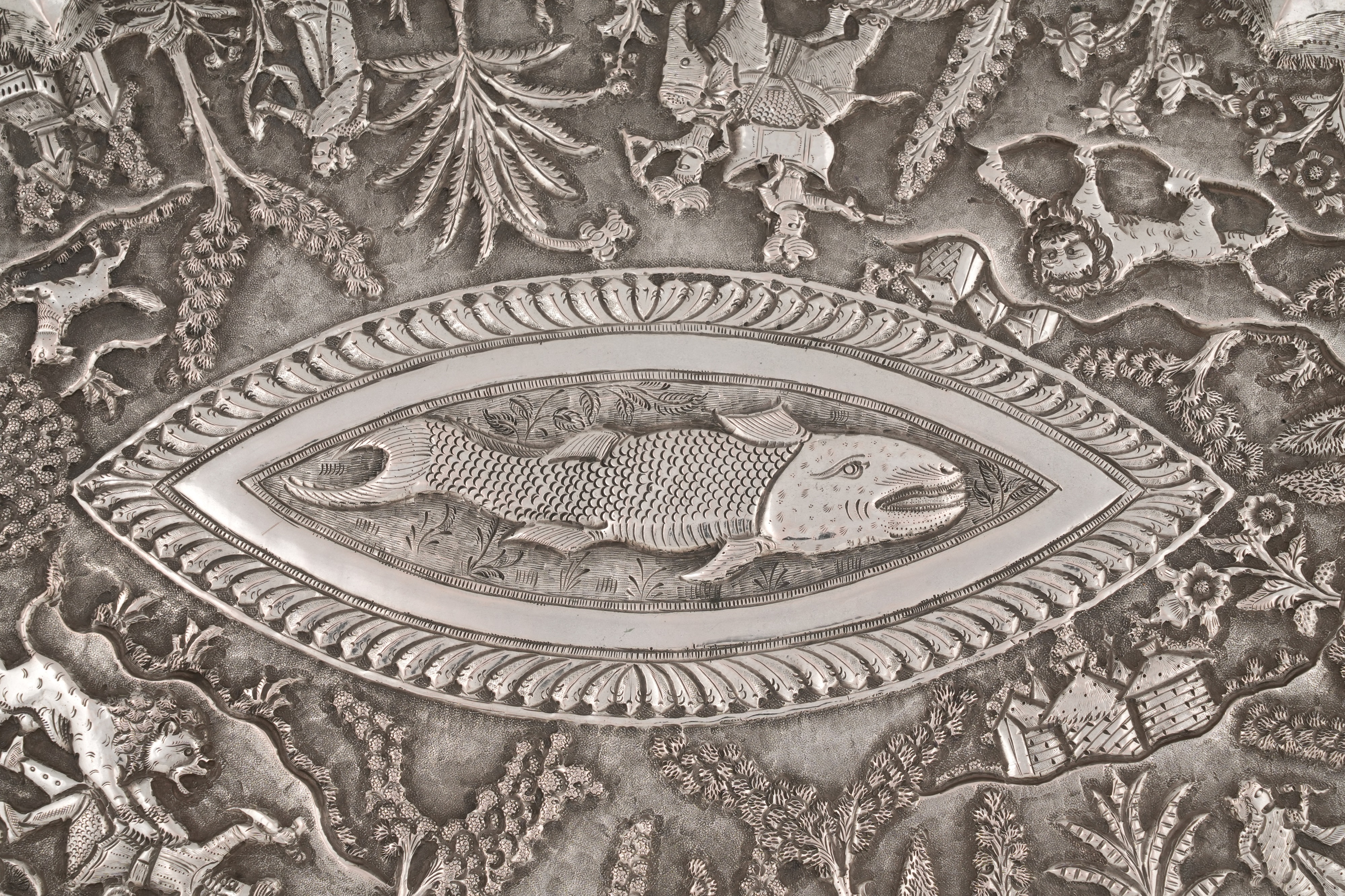 Lot 229 - AN INDIAN REPOUSSÉ SILVER SERVING TRAY WITH