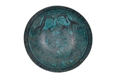 Lot 258 - A BLACK-PAINTED TURQUOISE-GLAZED SELJUK KASHAN-REVIVAL POTTERY DISH WITH COURTLY COUPLE