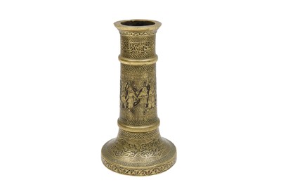 Lot 225 - AN ENGRAVED BRASS SAFAVID-STYLE CANDLESTICK WITH ARCHAISTIC FIGURES