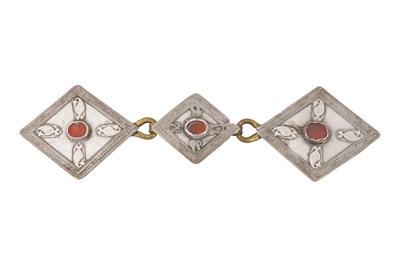 Lot 218 - A KAZAKH PARCEL-GILT SILVER RING AND A CARNELIAN-SET SILVER BELT BUCKLE
