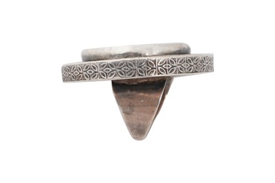 Lot 218 - A KAZAKH PARCEL-GILT SILVER RING AND A CARNELIAN-SET SILVER BELT BUCKLE