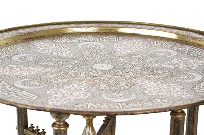Lot 193 - A MAMLUK-REVIVAL DAMASCUS-WARE SILVER AND COPPER-INLAID BRASS OCCASIONAL TABLE