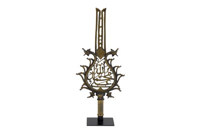 Lot 185 - AN INDIAN OPENWORK BRASS 'ALAM (STANDARD) WITH MAKARA HEADS