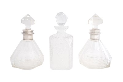 Lot 139 - A PAIR OF FRENCH SILVER COLLARED CUT GLASS DECANTERS