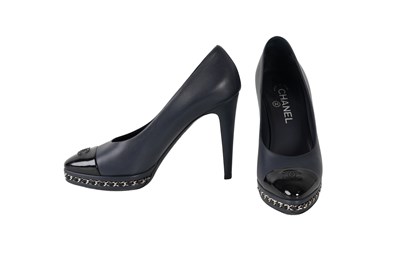 Lot 133 - CHANEL NAVY LEATHER CAP-TOE PUMPS WITH CHAIN DETAIL