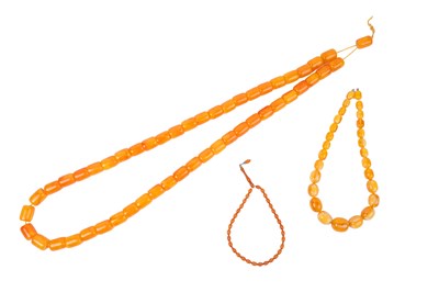 Lot 13 - THREE AMBER TYPE BEAD NECKLACES