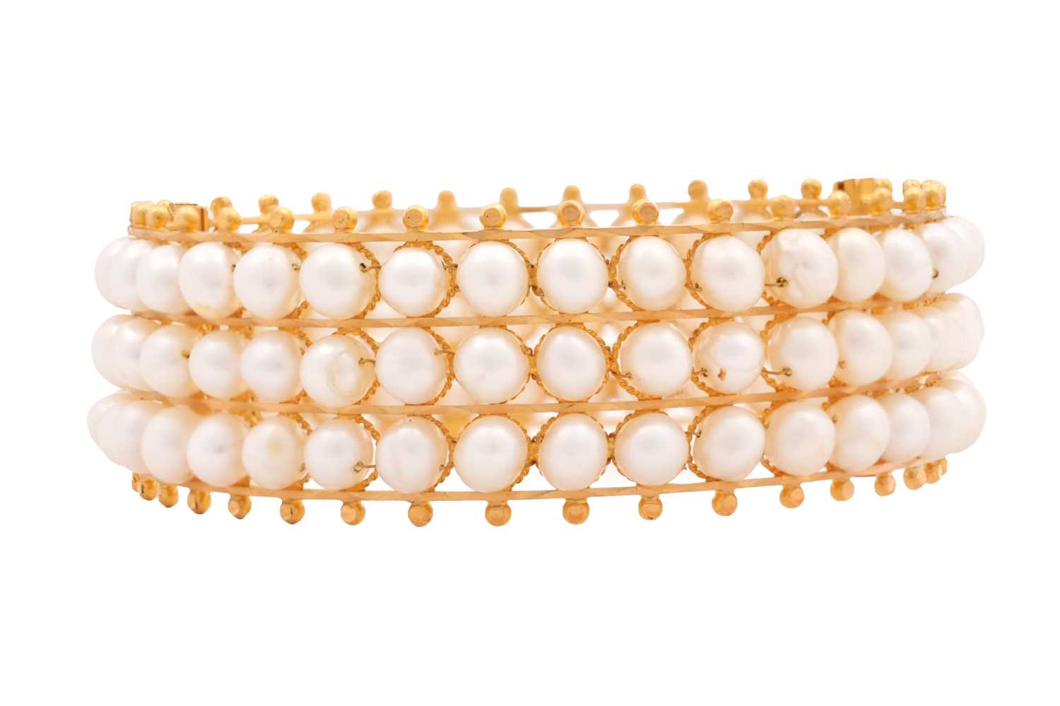 Lot 73 - A GOLD AND PEARL HINGED CUFF BRACELET