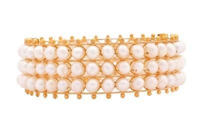 Lot 73 - A GOLD AND PEARL HINGED CUFF BRACELET