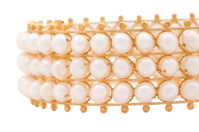 Lot 73 - A GOLD AND PEARL HINGED CUFF BRACELET