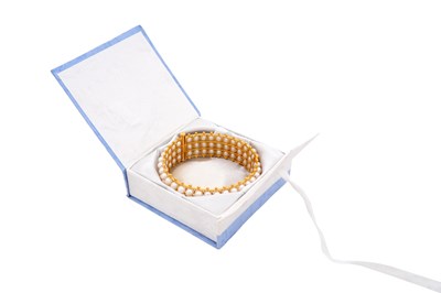 Lot 73 - A GOLD AND PEARL HINGED CUFF BRACELET