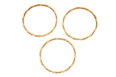 Lot 75 - A SET OF THREE GOLD BANGLES