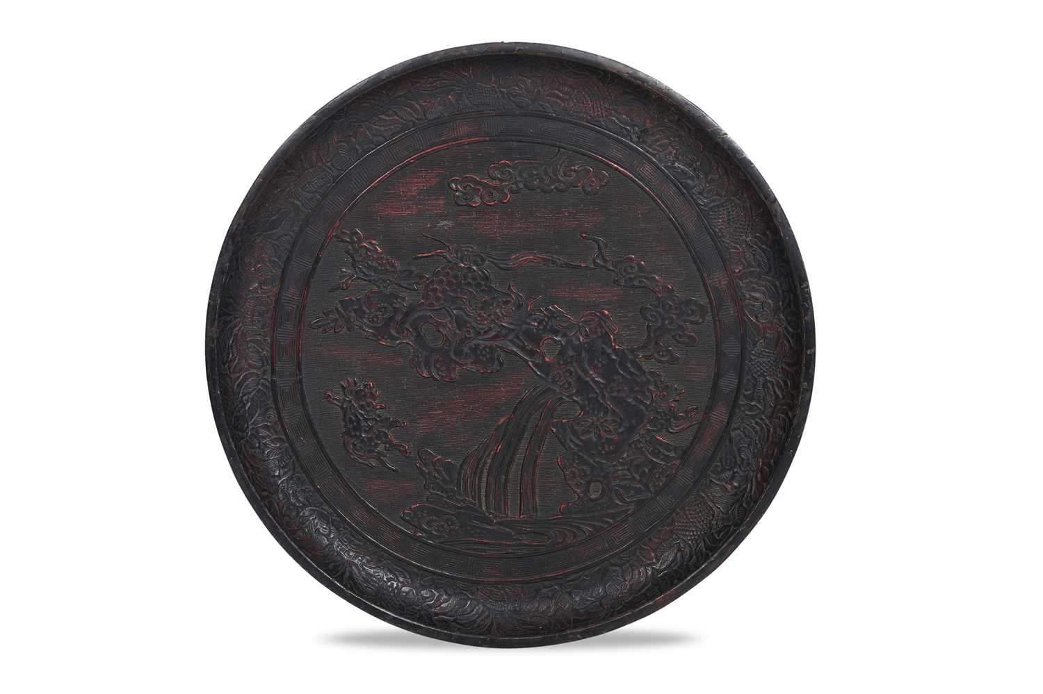 Lot 10 - A JAPANESE NEGORO LACQUER 'LION DOG' DISH