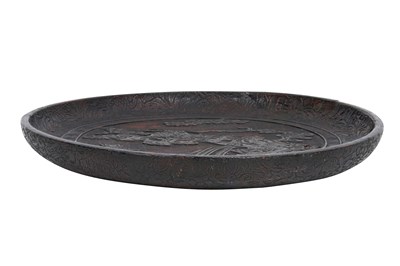 Lot 10 - A JAPANESE NEGORO LACQUER 'LION DOG' DISH