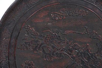 Lot 10 - A JAPANESE NEGORO LACQUER 'LION DOG' DISH