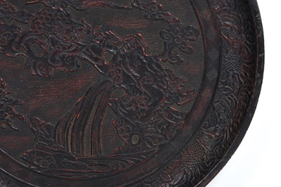 Lot 10 - A JAPANESE NEGORO LACQUER 'LION DOG' DISH