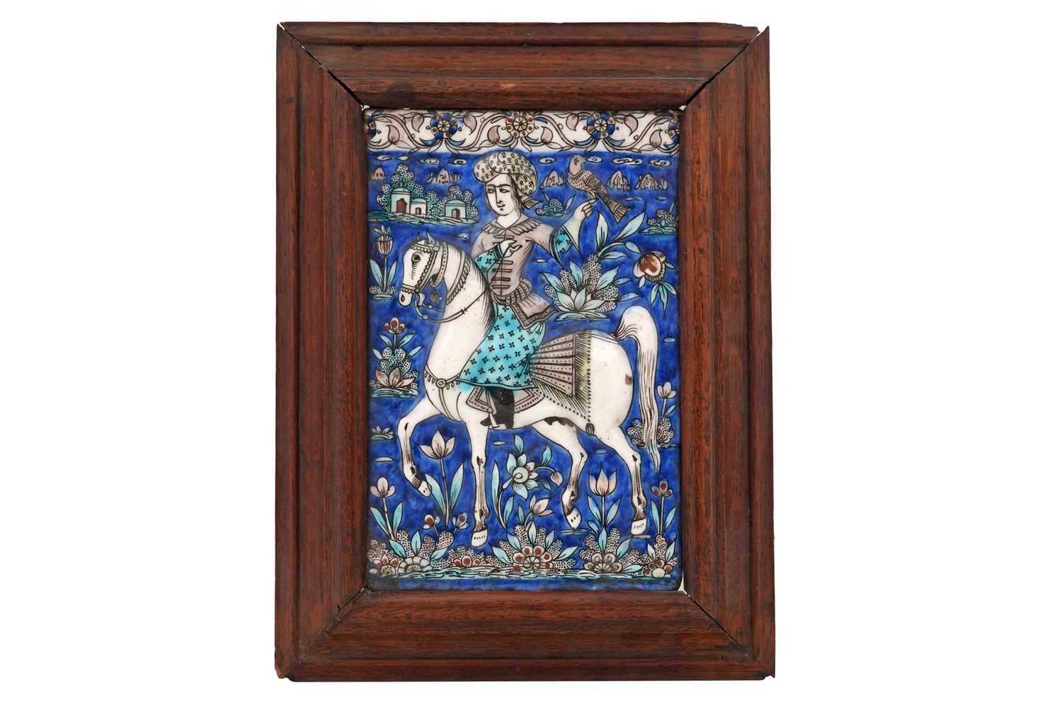 Lot 20 - A QAJAR POTTERY TILE OF A FALCONER ON HORSEBACK