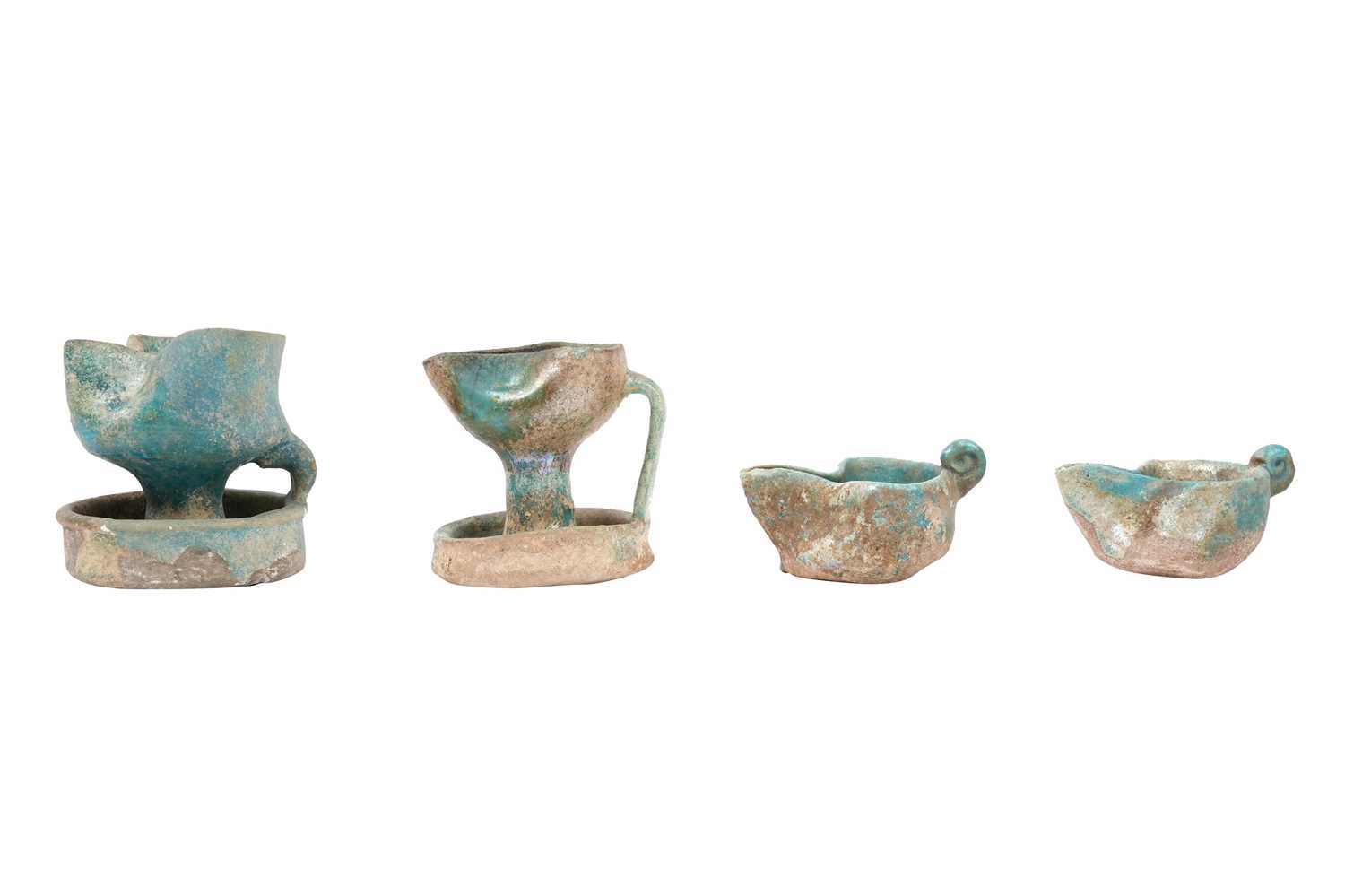 Lot 6 - A COLLECTION OF FOUR PERSIAN SELJUK GLAZED POTTERY OIL LAMPS