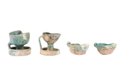Lot 6 - A COLLECTION OF FOUR PERSIAN SELJUK GLAZED POTTERY OIL LAMPS