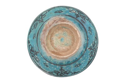 Lot 7 - A LARGE KASHAN SILHOUETTE-WARE TURQUOISE GLAZED POTTERY BOWL