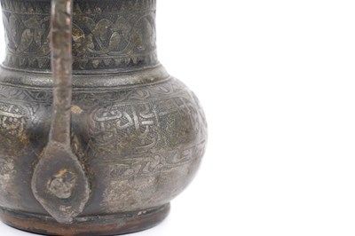 Lot 36 - A TIMURID ENGRAVED TINNED COPPER JUG (MASHRABE)