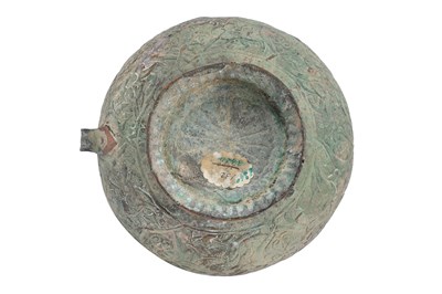 Lot 28 - AN EMBOSSED COPPER JUG WITH MYTHICAL CREATURES AND KUFIC CALLIGRAPHY