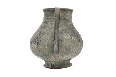 Lot 28 - AN EMBOSSED COPPER JUG WITH MYTHICAL CREATURES AND KUFIC CALLIGRAPHY