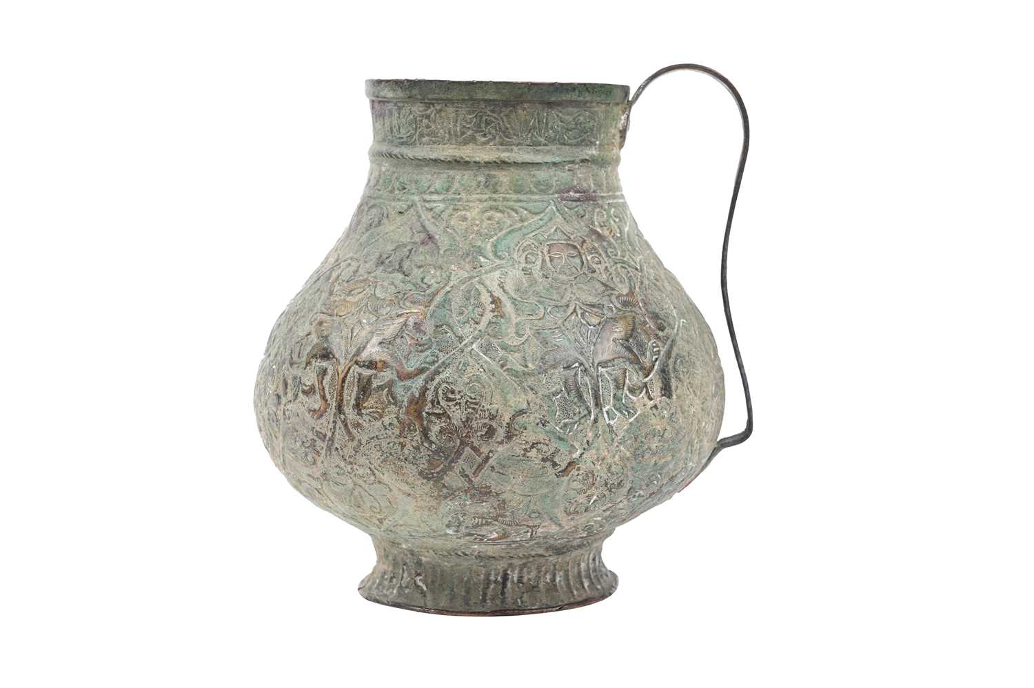 Lot 28 - AN EMBOSSED COPPER JUG WITH MYTHICAL CREATURES AND KUFIC CALLIGRAPHY