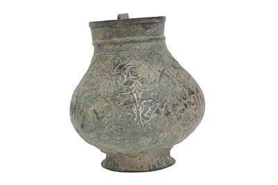Lot 28 - AN EMBOSSED COPPER JUG WITH MYTHICAL CREATURES AND KUFIC CALLIGRAPHY