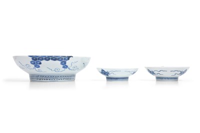 Lot 24 - A JAPANESE BLUE AND WHITE NABESHIMA ‘WISTERIA’ DISH AND TWO NABESHIMA ‘WILD ORCHID’ SAUCERS