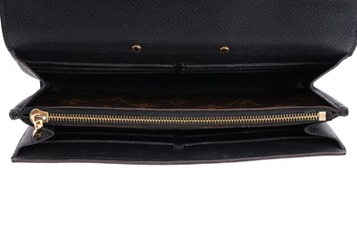 Lot 139 - A LOUIS VUITTON MONOGRAM CANVAS AND BLACK LEATHER S-LOCK LONG WALLET