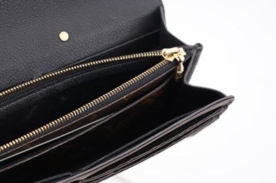 Lot 139 - A LOUIS VUITTON MONOGRAM CANVAS AND BLACK LEATHER S-LOCK LONG WALLET