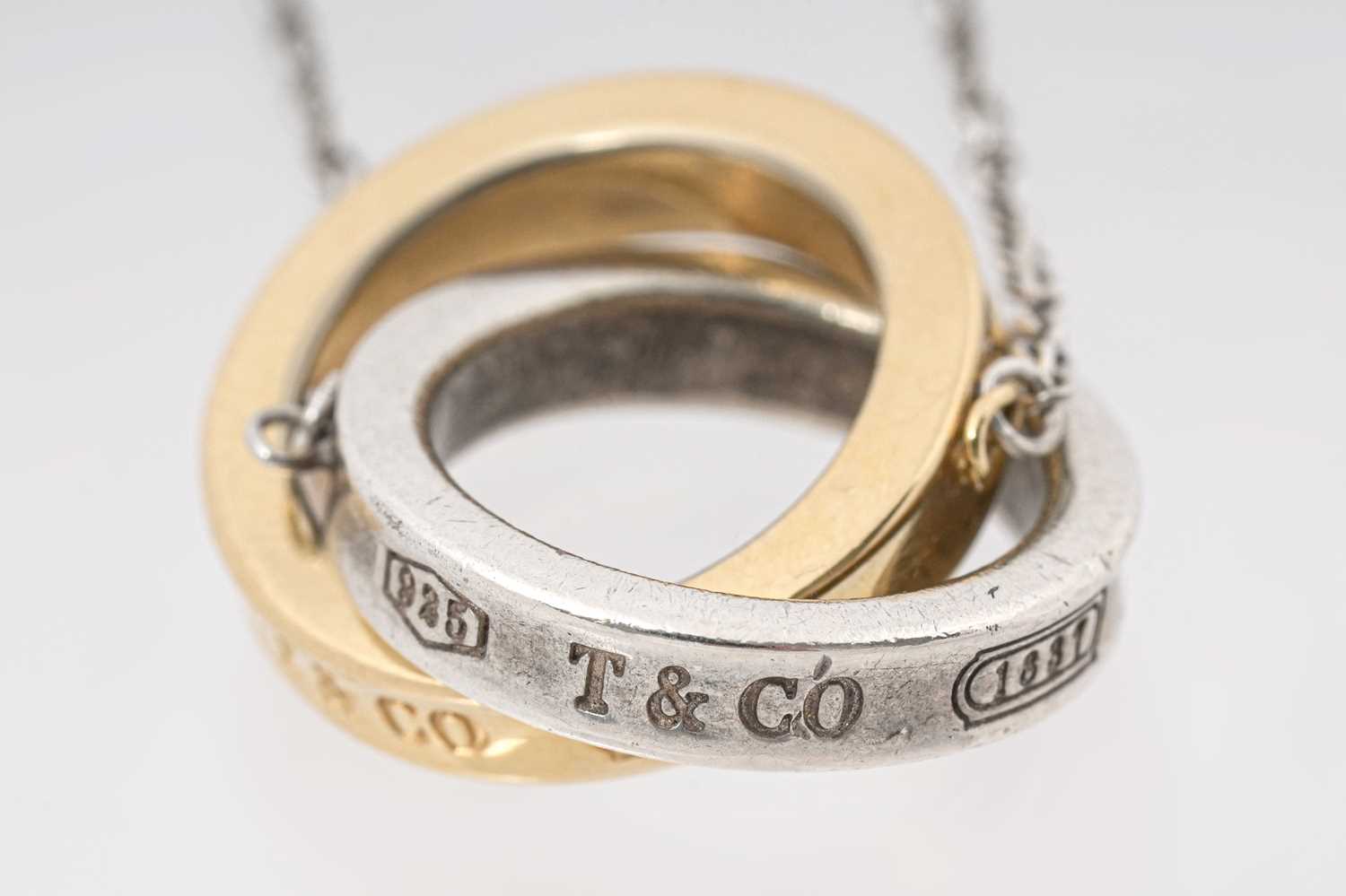 Lot 25 - A TIFFANY & CO. STERLING SILVER AND 18CT ROSE GOLD 'INTERLOCKING CIRCLES' PENDANT NECKLACE