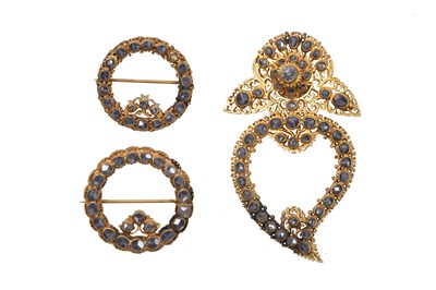 Lot 59 - THREE ENCRUSTED PARCEL-GILT BROOCHES