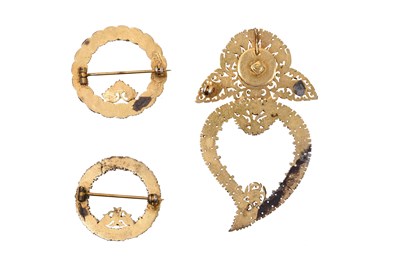 Lot 59 - THREE ENCRUSTED PARCEL-GILT BROOCHES