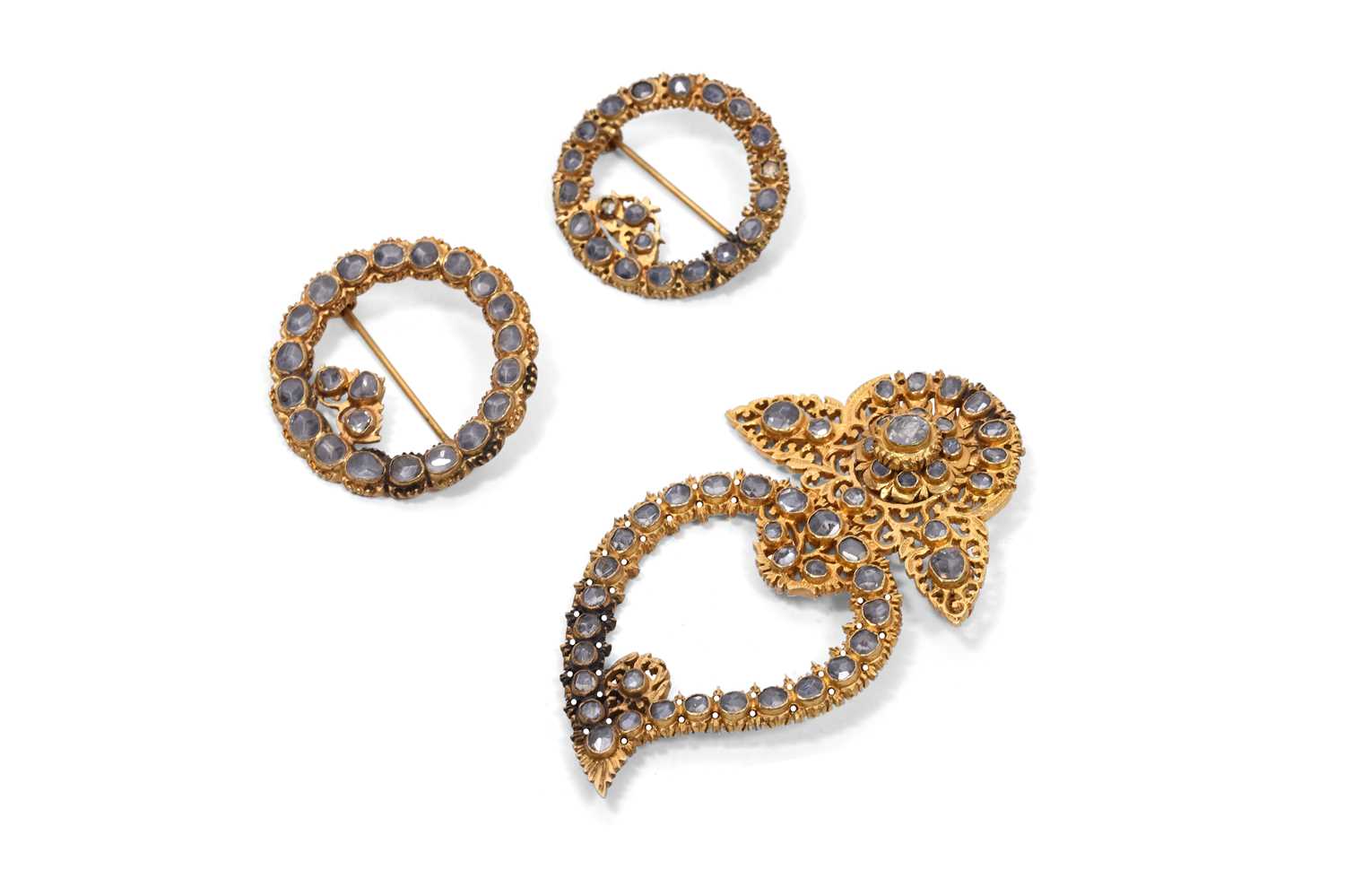 Lot 59 - THREE ENCRUSTED PARCEL-GILT BROOCHES
