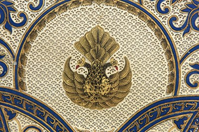 Lot 50 - A PIERCED, GILT AND PAINTED HIDE FAN WITH HORN HANDLE