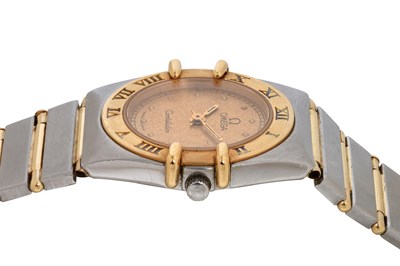 Lot 9 - A LADIES 18K YELLOW GOLD AND STAINLESS STEEL QUARTZ BRACELET WATCH.